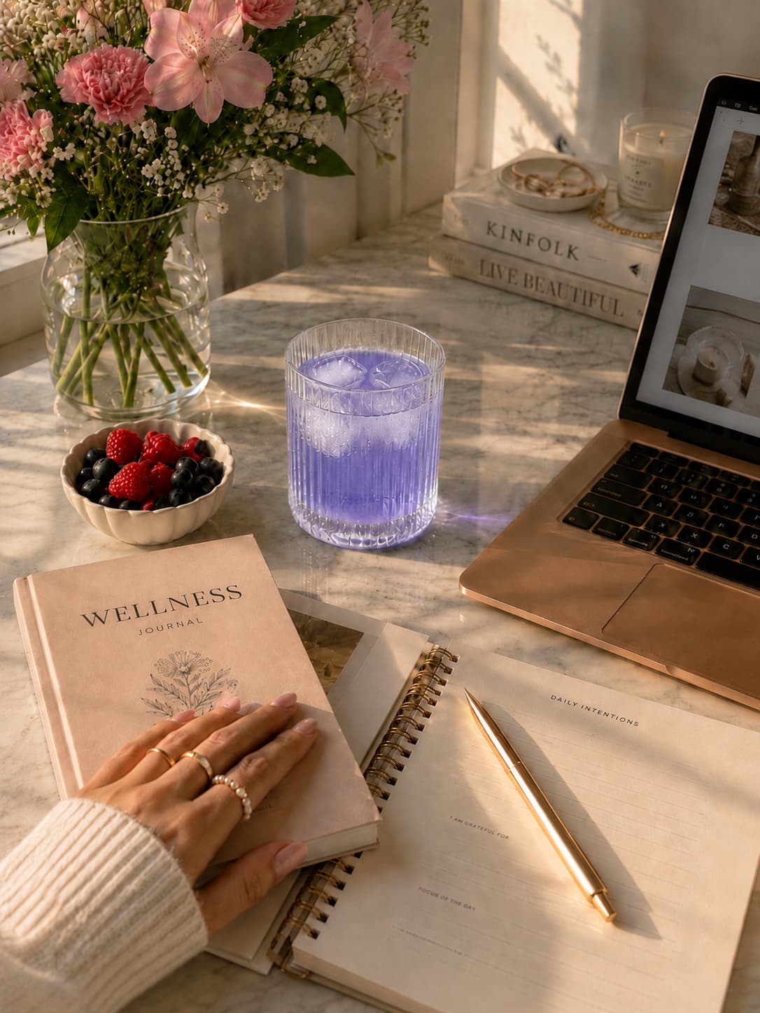 An open journal beside a botanical drink in soft natural light